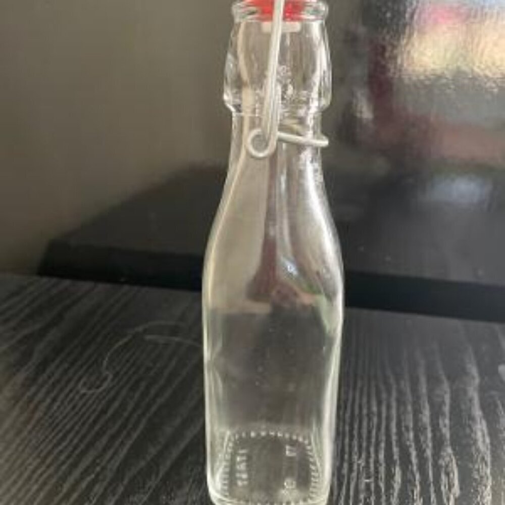 Eight Ounce Clear Bottle With Swing Lid. Italy
